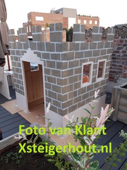 Speelhuisje buiten als kasteel geverfd